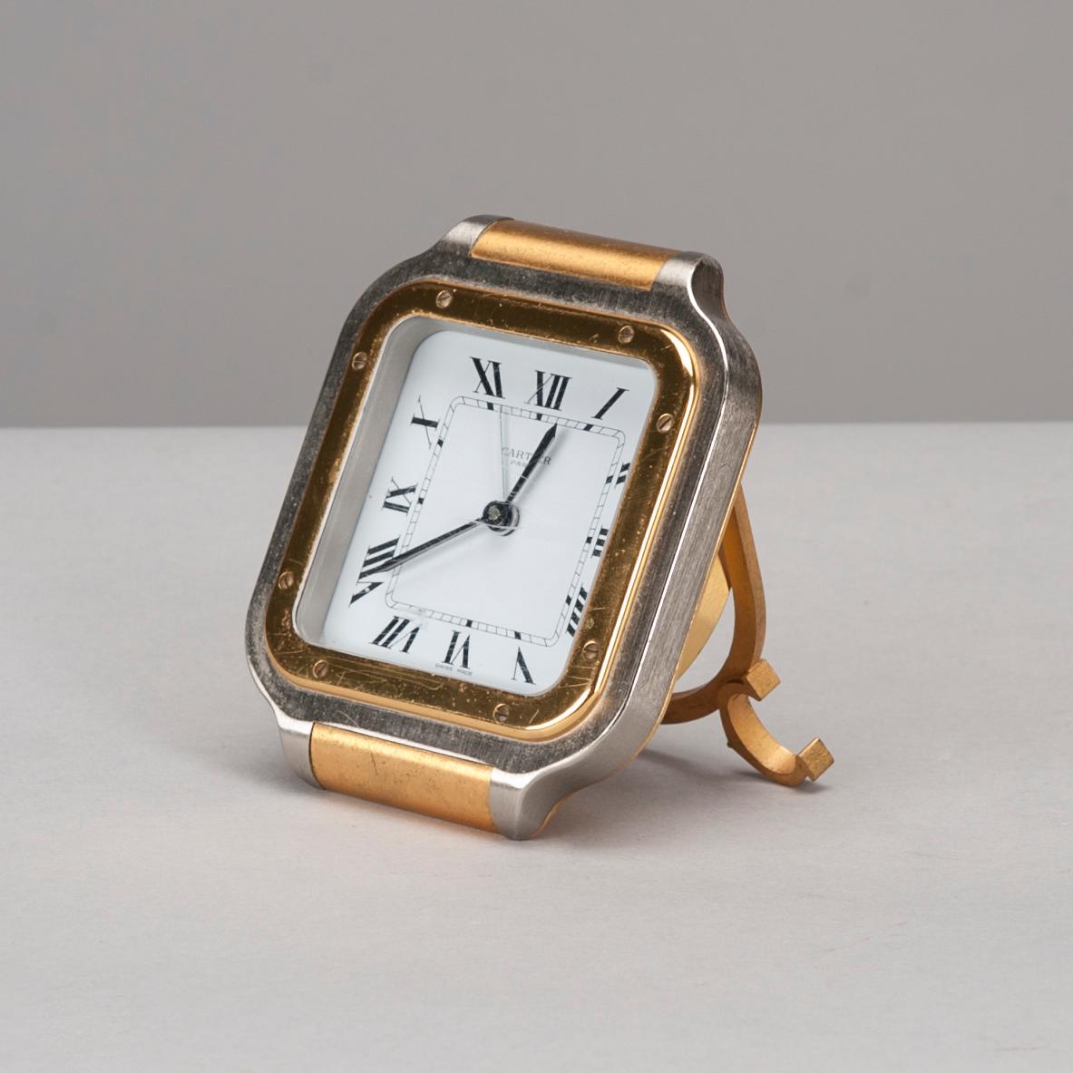 A CARTIER TABLE CLOCK, steel with gidt decoration, late 20th century.