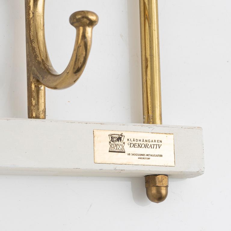 A pair of 'Dekorativ' coat hangers, Skoglunds metallgjuteri, Anderstorp, mid 20th Century.