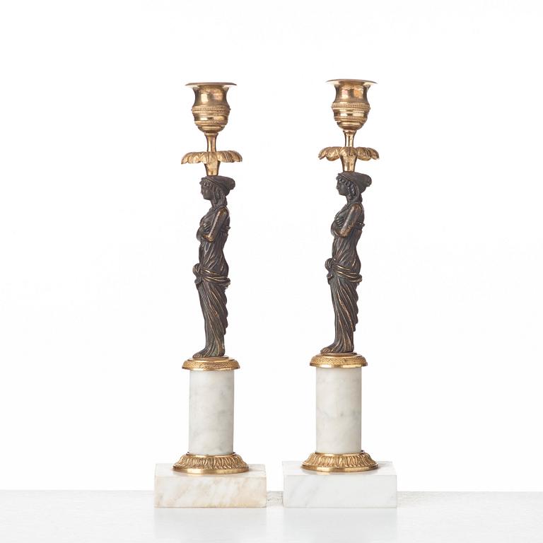 A pair of late Gustavian circa 1800 white marble and bronze candlesticks.