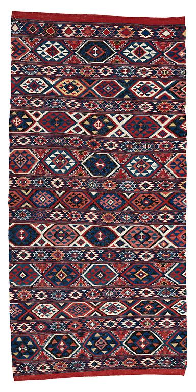 A CARPET, AN ANTIQUE AZERI KILIM, probably a Shirvan, ca 250 x 117,5 cm.