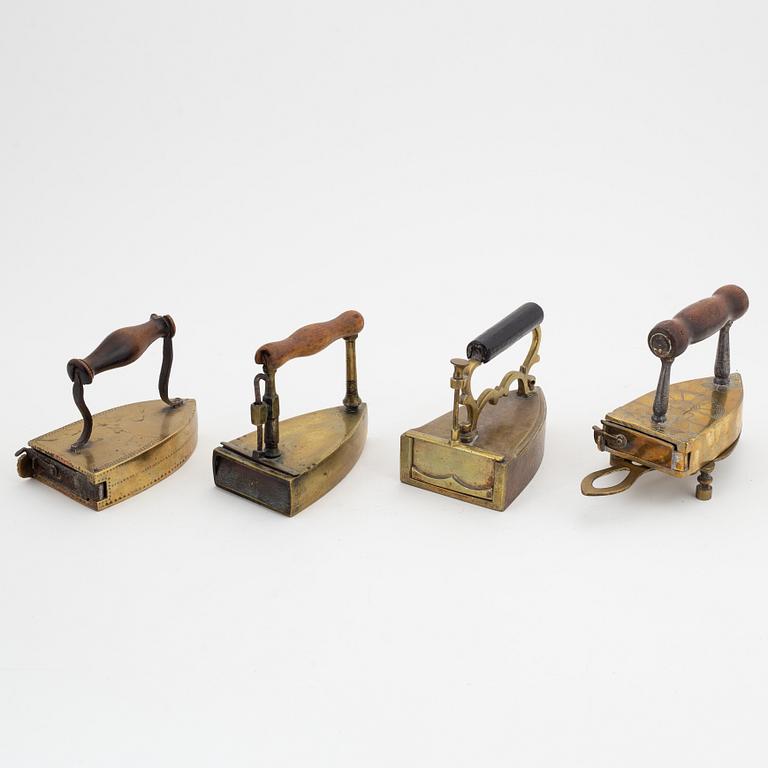 A set of four Swedish brass irons, 18th/19th Century.