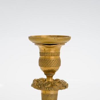 A pair of Empire ormolu brass candlesticks, France early 19th century.