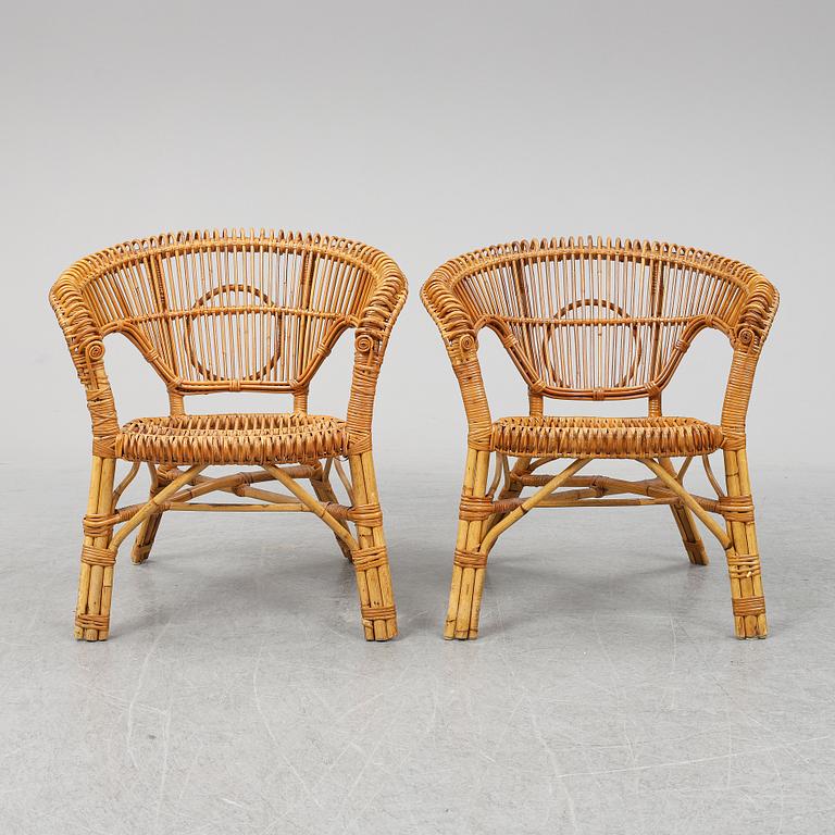 A pair of rattan chairs.