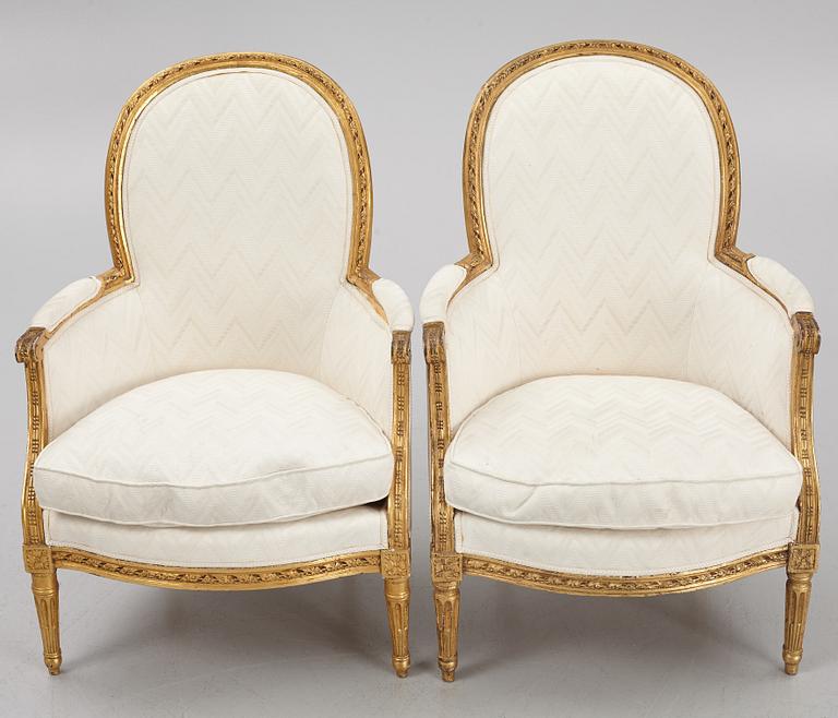 A near pair of French Louis XVI giltwood bergères, Paris, late 18th century.