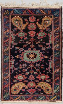 A RUG, an old Kurdish probably, ca 140,5-143,5 x 94,5-102 cm (as well as 2 cm flat weave at each end).