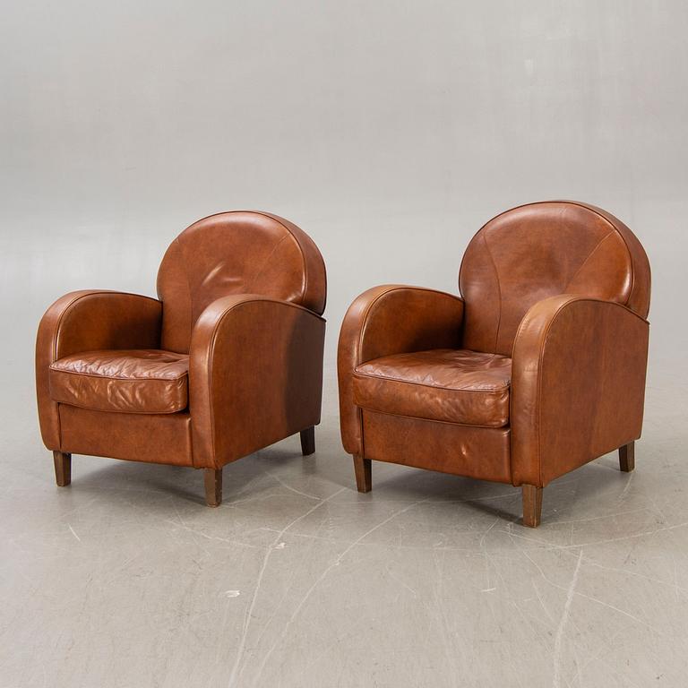 A pair of leather easy chairs later part of the 20th century.