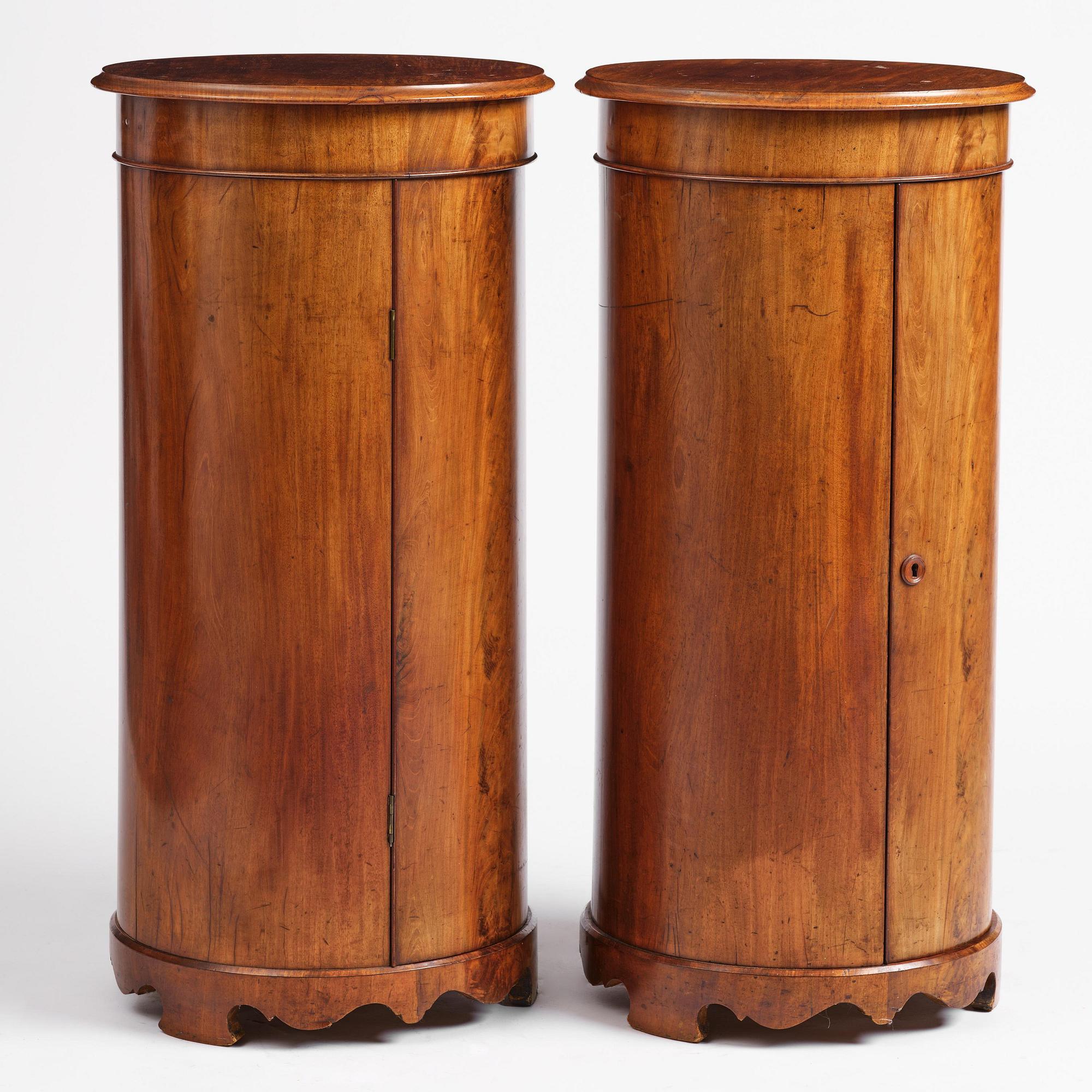 A pair of late Empire mahogany column cabinets, mid 19th Century.
