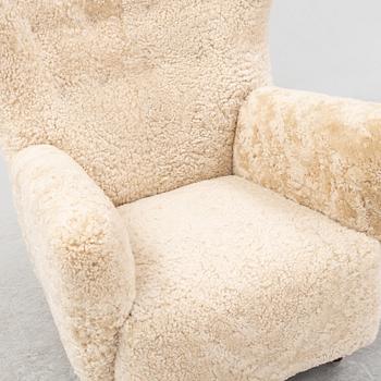 A sheepskin upholstered wing back lounge chair, 1940s.