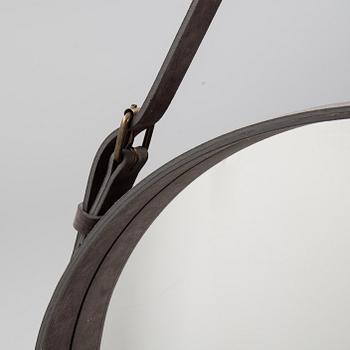 A mirror "Adnet" with leather hanging in original box, designed 1950 by Jacques Adnet for Gubi, Denmark.