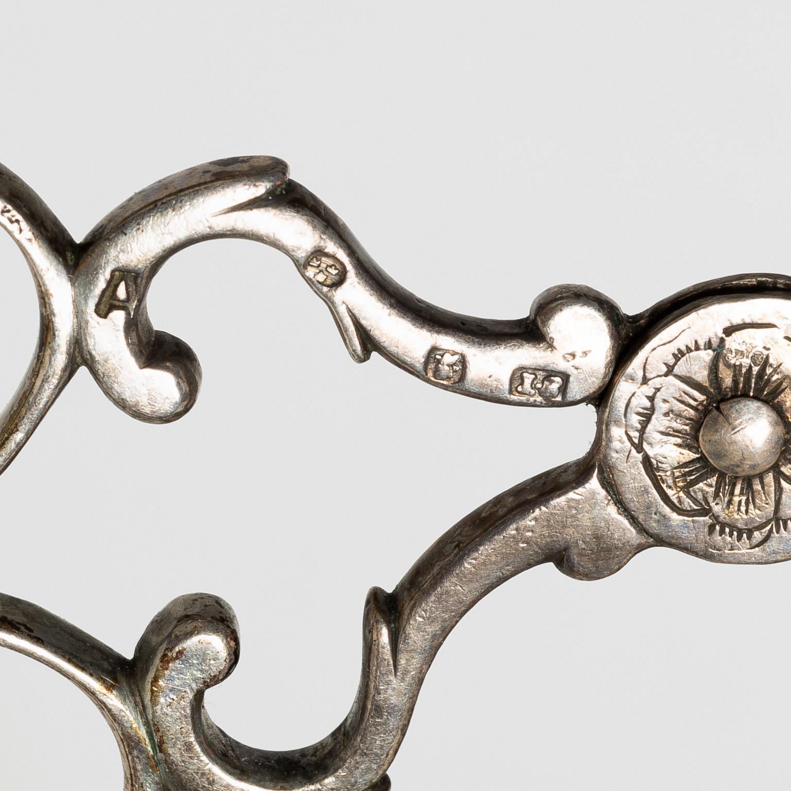 A pair of Swedish silver sugar tongs, mark of Isak Sauter, Stockholm, 1759. Rococo.