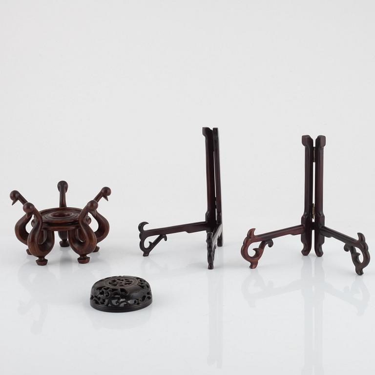 Seven hardwood stand for plates and vase, and one lid, China, 20th century.