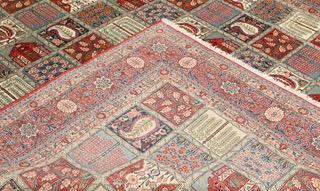 A semi-antique Ghom carpet, approx. 318 x 241 cm.