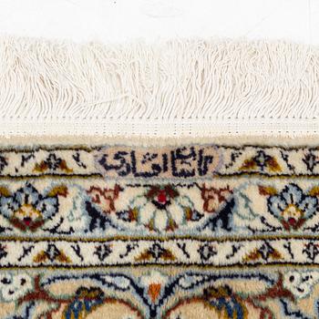 A Keschan carpet, signed, c. 350 x 245 cm.