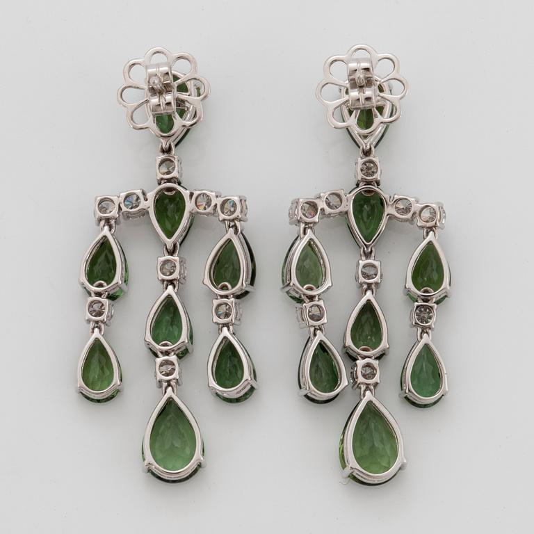 A pair of chandelier earrings in 18K white gold set with green tourmalines and round brilliant-cut diamonds.