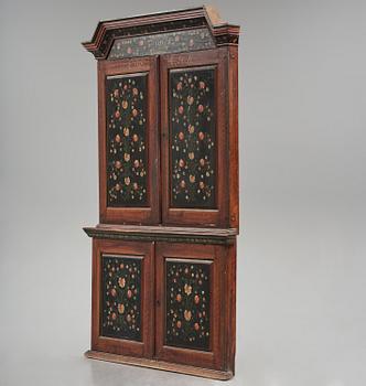 A Swedish polychrome painted folk art corner cabinet, dated 1818.
