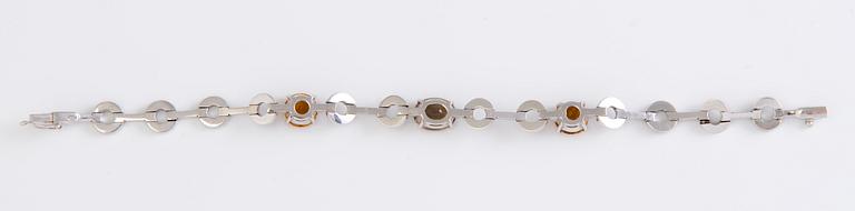 An 18K white gold bracelet with citrines, smoky quartz and diamonds.