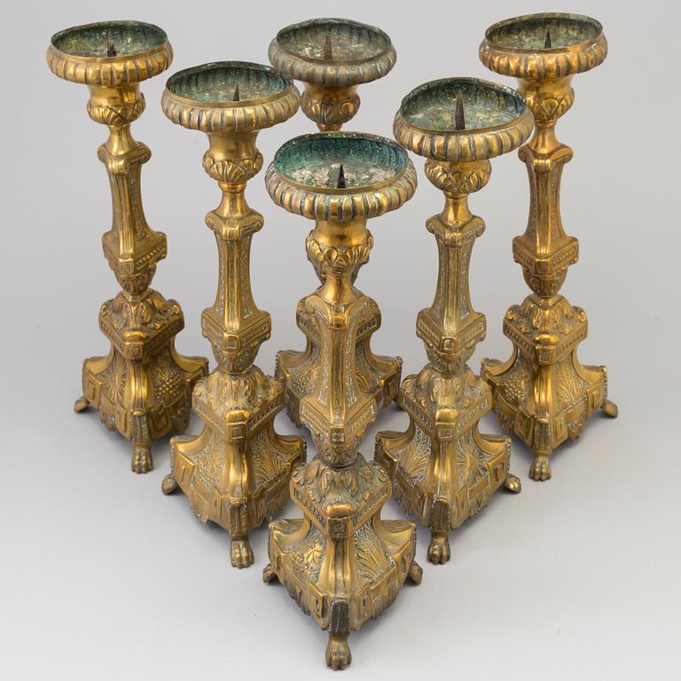 Six late 18th century brass candlesticks.