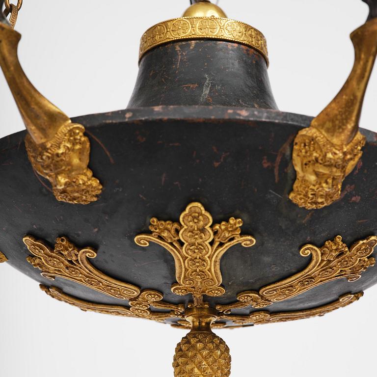 A patinated and ormolu six-light Empire chandelier, Stockholm, first part 19th century.