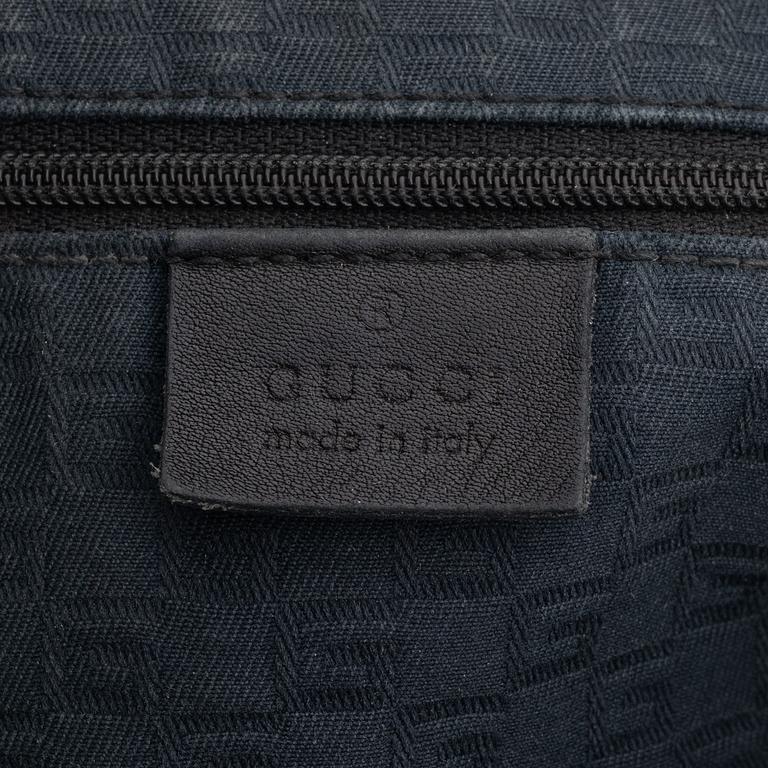 Gucci, a leather bag.