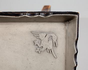 A Firma Svenskt Tenn pewter tray on a birch base, Stockholm 1928.