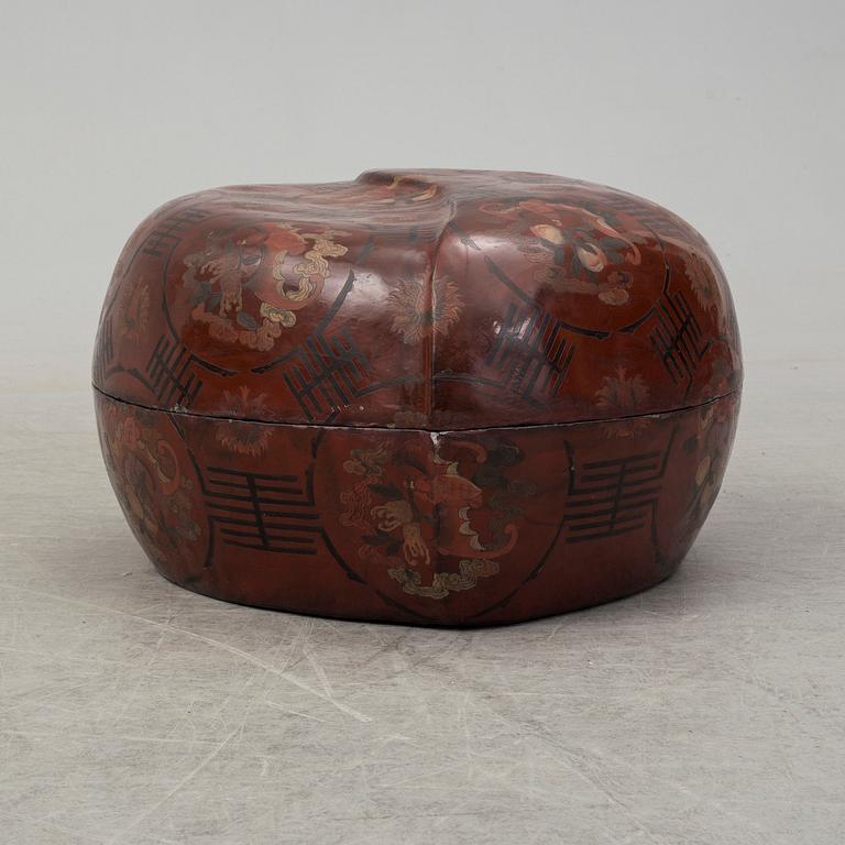 A massive Japanese wooden and lacquered box with cover, in the shape of a peach, early 20th century.