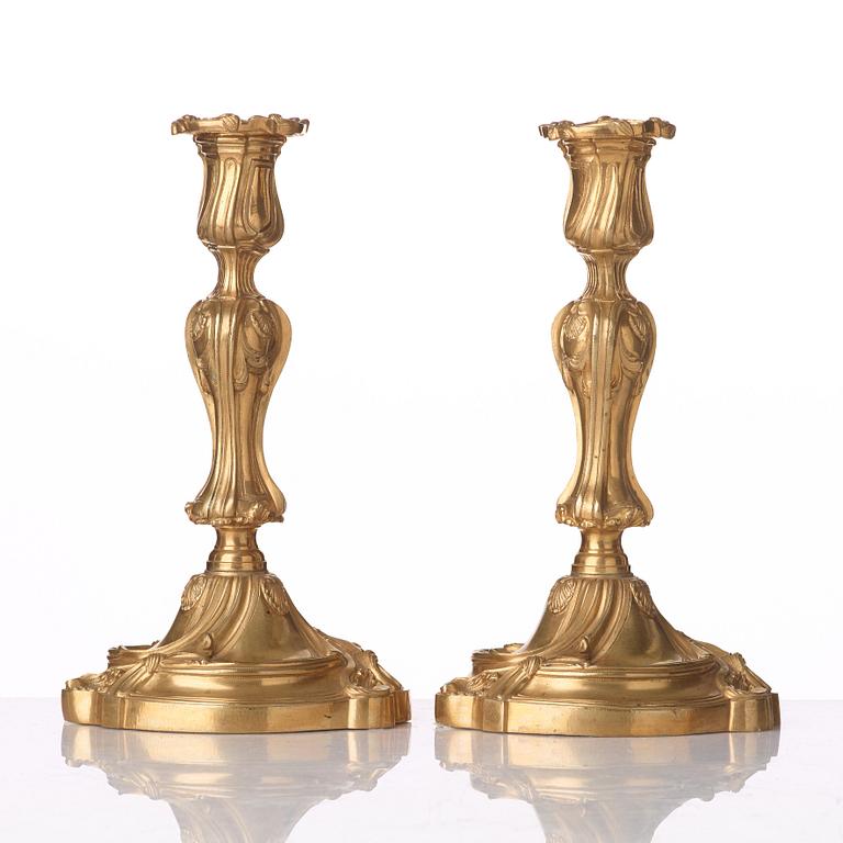 A pair of French Louis XV mid 18th century gilt bronze candlesticks.