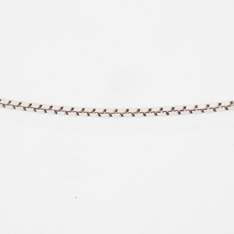 An 18K white gold necklace set with a drop-shaped cultured pearl and round brilliant-cut diamonds.