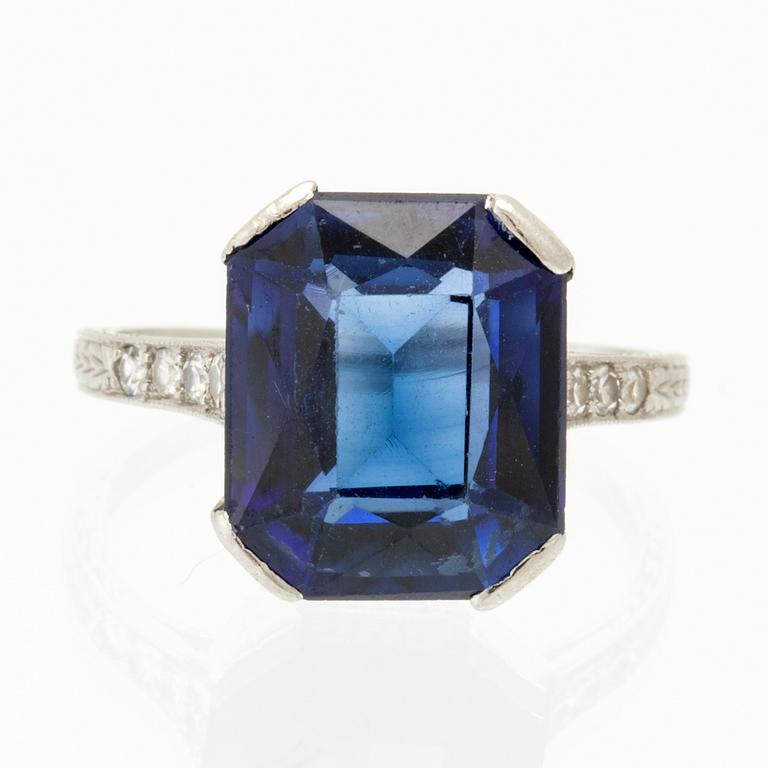 A Shreve & Co Platinum Ring set with a Synthetic Sapphire and Round Brilliant Cut Diamonds.