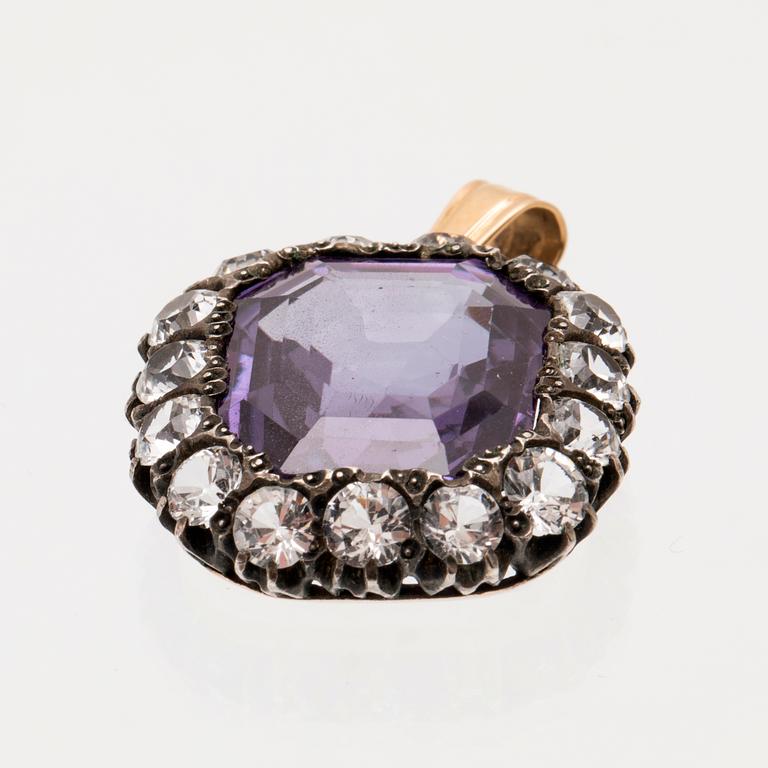 Pendant in low-grade gold and silver set with a synthetic color-changing purple sapphire, and synthetic stones.