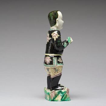 A famille noir figure of a man, Qing dynasty, Kangxi (1662-1722).