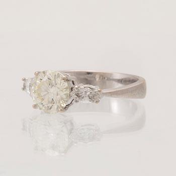 An 18K white gold ring set with one round brilliant-cut diamond and two marquise-cut diamonds.