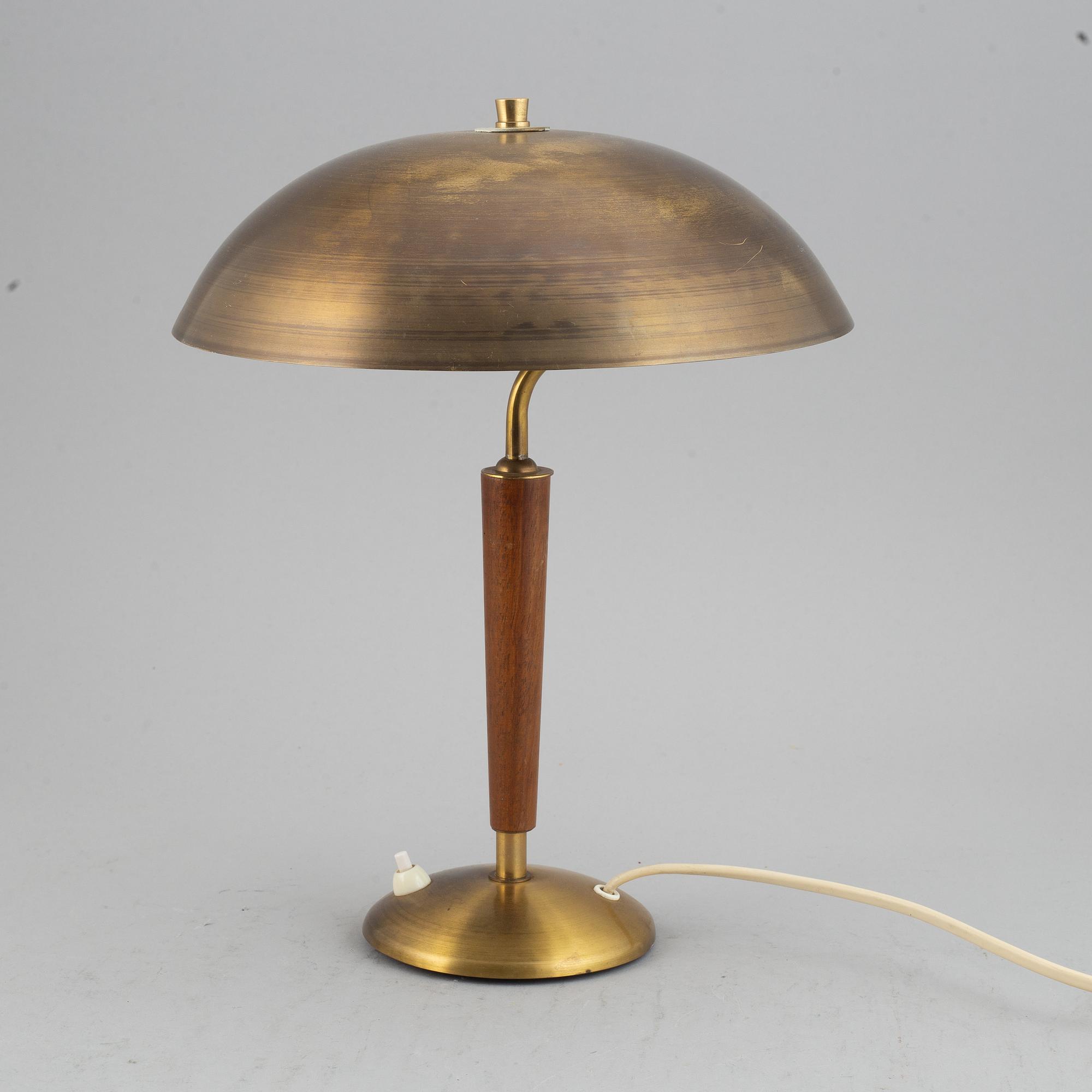 A brass and teak table lamp, 1960's.