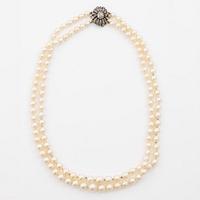 Two-row cultured pearl necklace with a silver and 18K gold clasp set with rose-cut diamonds.