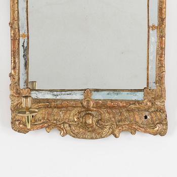 A second half of the 18th century rococo mirror sconce.