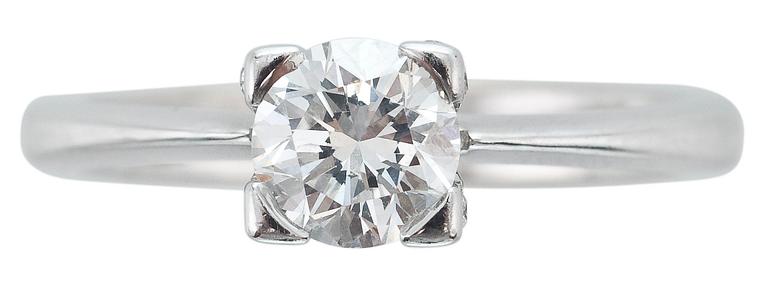 A RING, brilliant cut diamond c. 0.85 ct and small diamonds c. 0.30 ct in total.