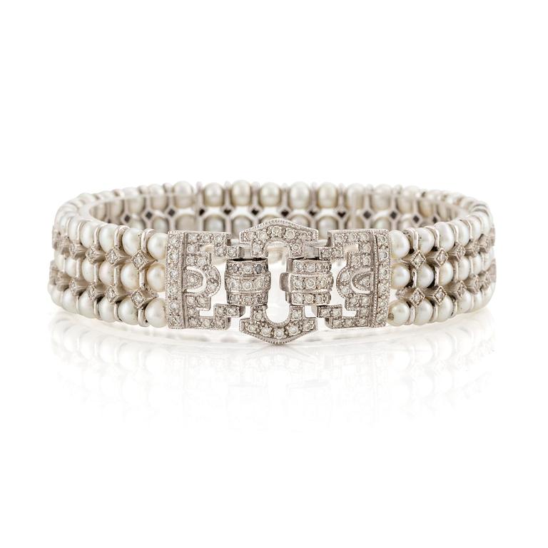 An 18K white gold bracelet set with cultured pearls and round brilliant-cut diamonds.