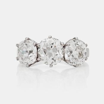 A three stone old mine and old cushion cut diamond ring. Total carat weight 4.01cts.