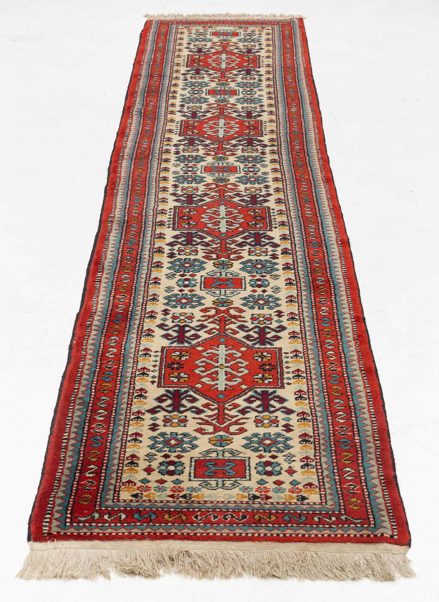 An oriental runner, c. 355 x 75 cm.