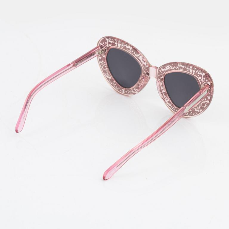 Karen Walker, a pair of pink "Intergalactic" sunglasses.