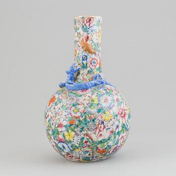 A chinese globular shaped vase, richly decorated with flowers and a dragon and a bat, second half of the 20th century.