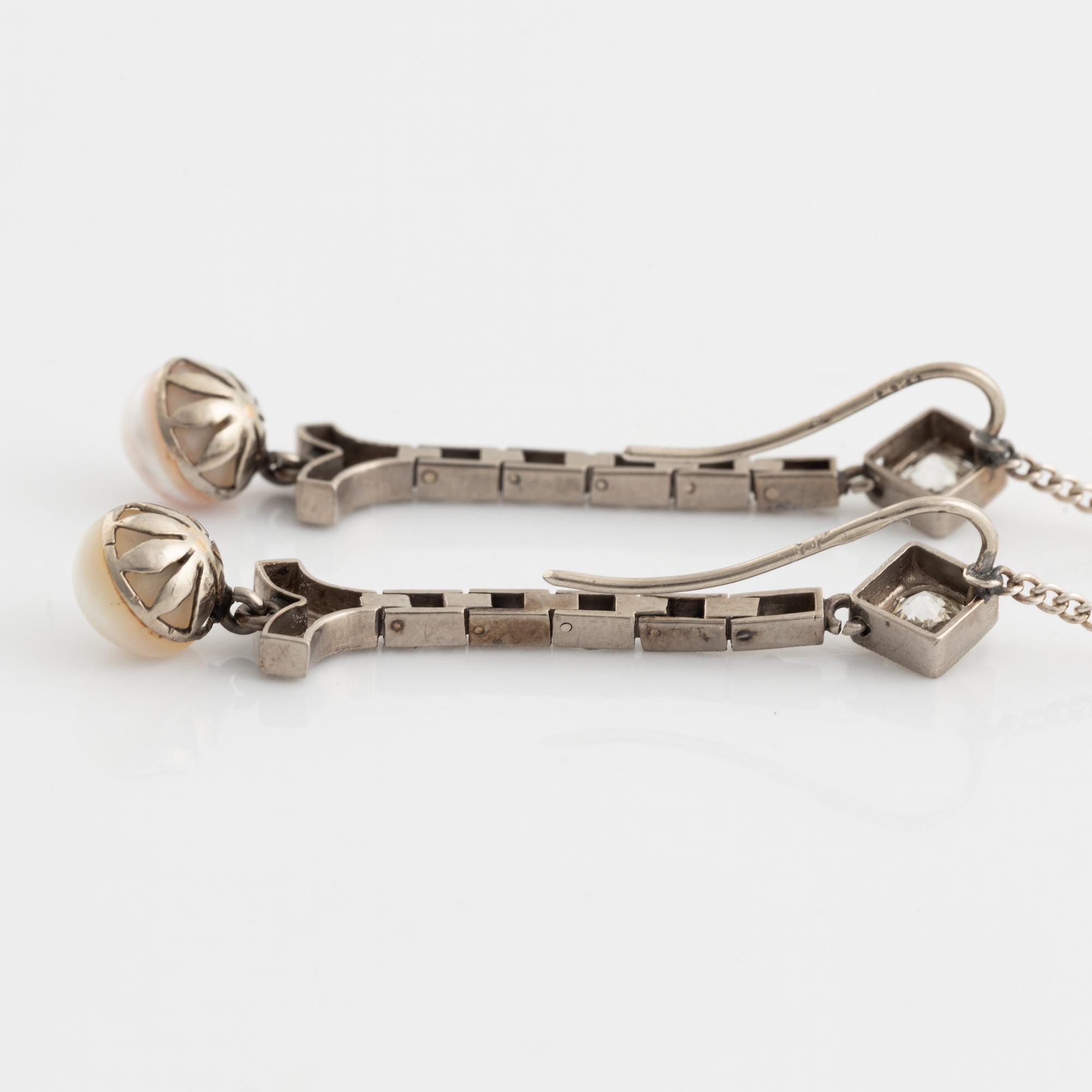 A pair of 18K gold and cultured halfpearl and diamond earrings.