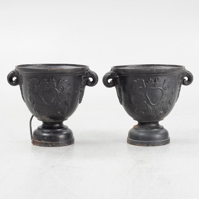 A pair of cast iron garden urns, later part of the 20th century.