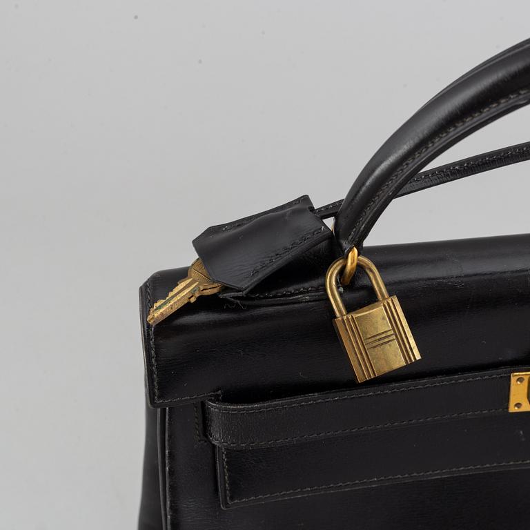 Hermès,a black leather 'Kelly 32' handbag, 1975.