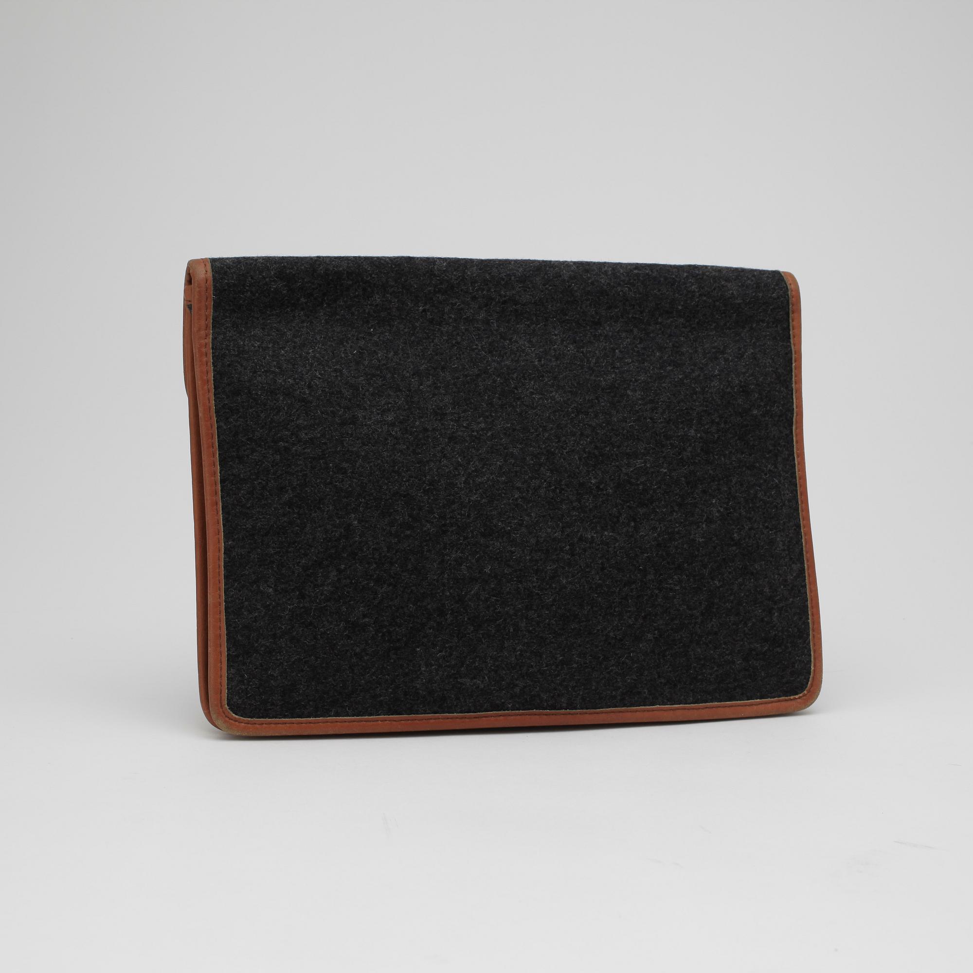 CÉLINE, a grey clutch bag.