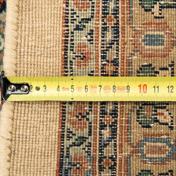 An oriental carpet. Circa 345x245 cm.