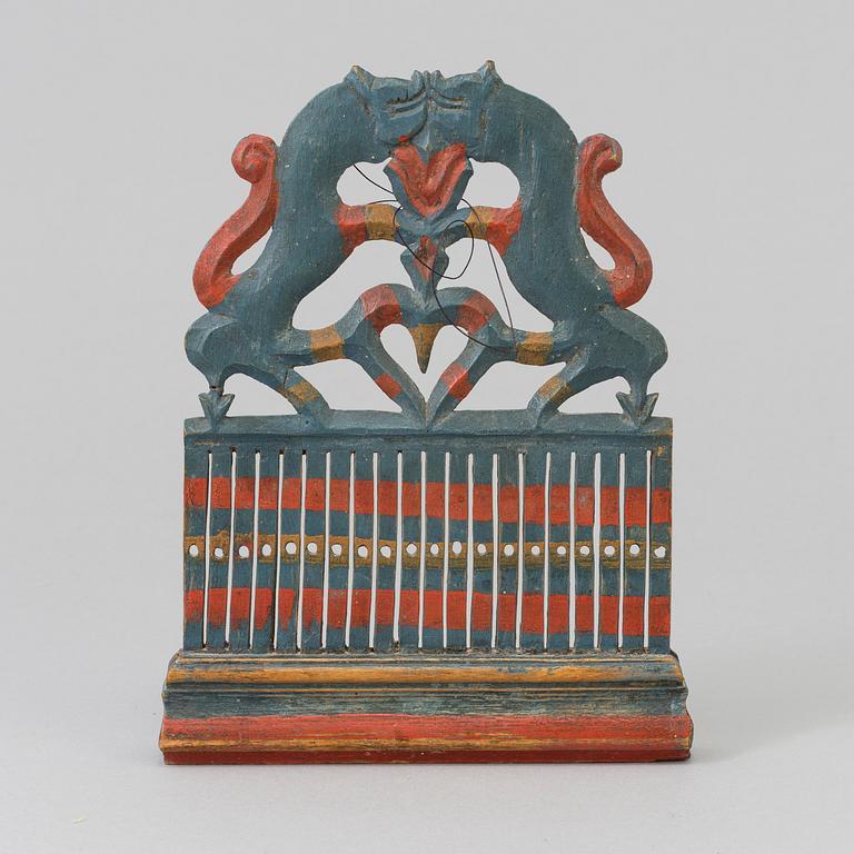 a painted wooden loom from the 19th century.