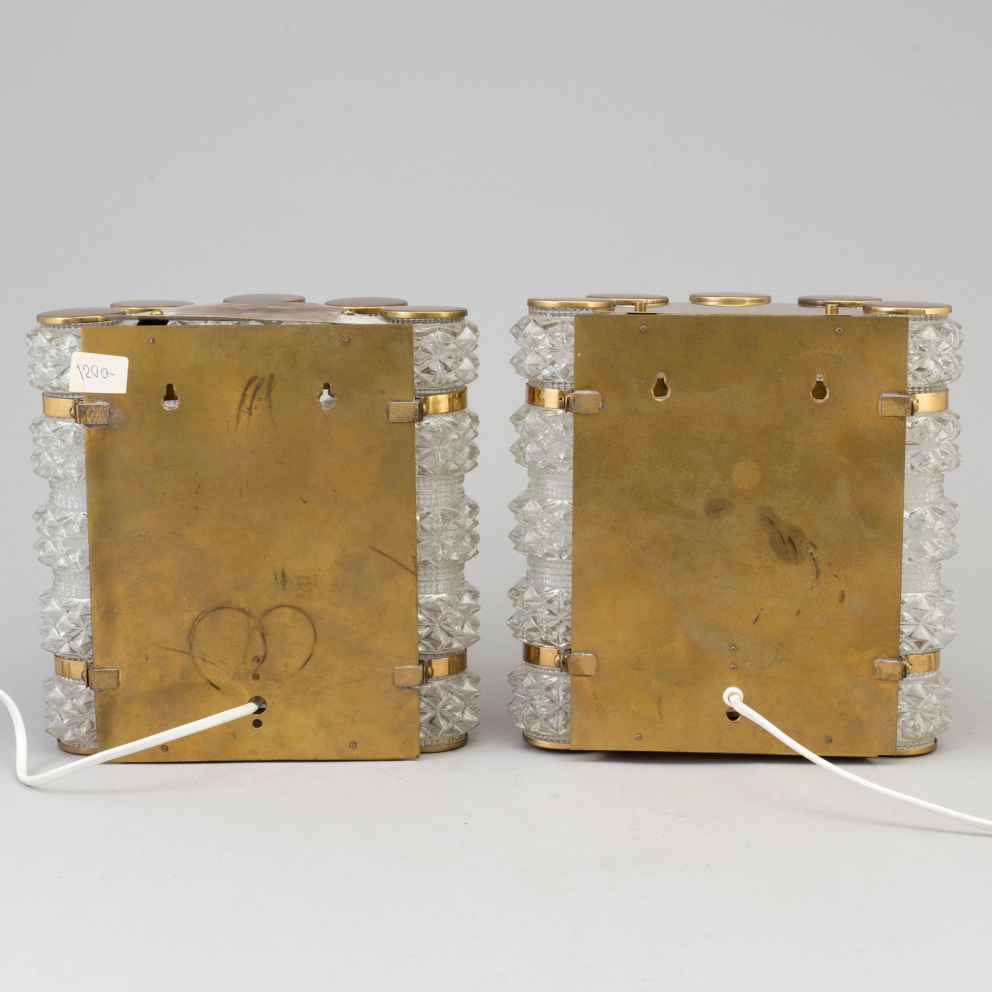 A pair of 1970's glass and brass wall lamps.