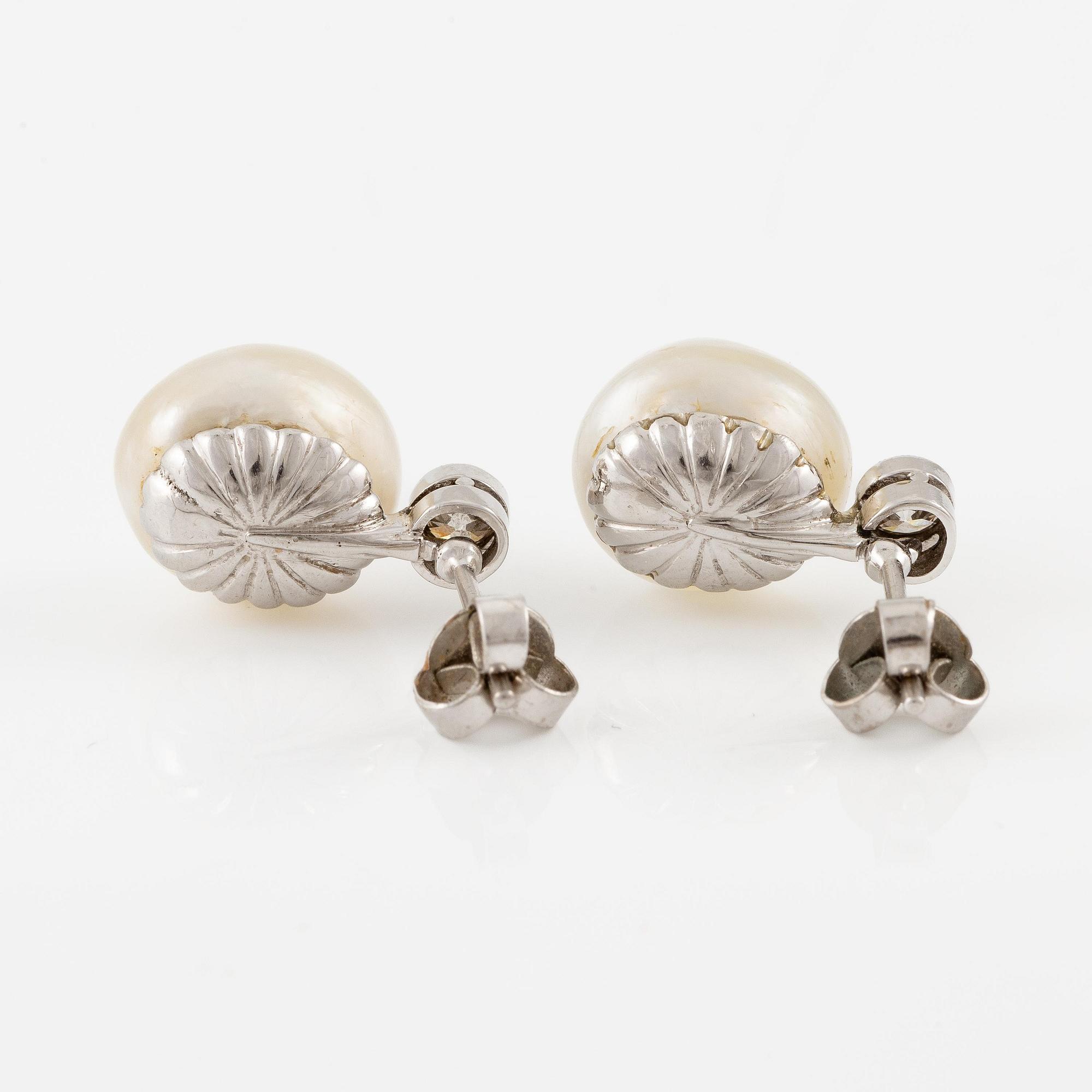 A pair of platinum earrings with bouton pearls and old-cut diamonds.