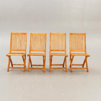 A set of four chairs and a table Royal teak and others, later part of the 20th century.