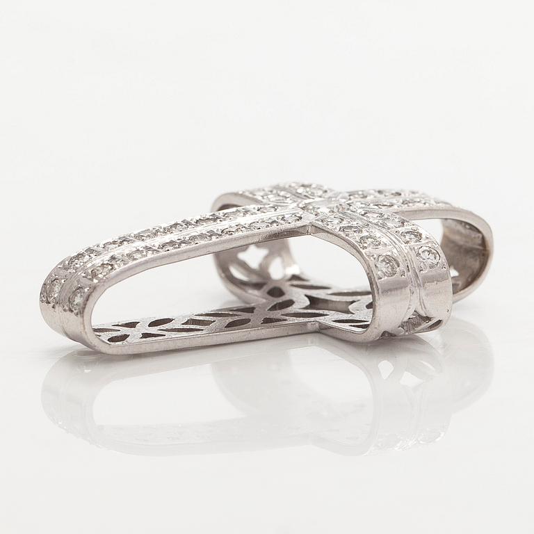 An 18K white gold cross pendant with diamonds.